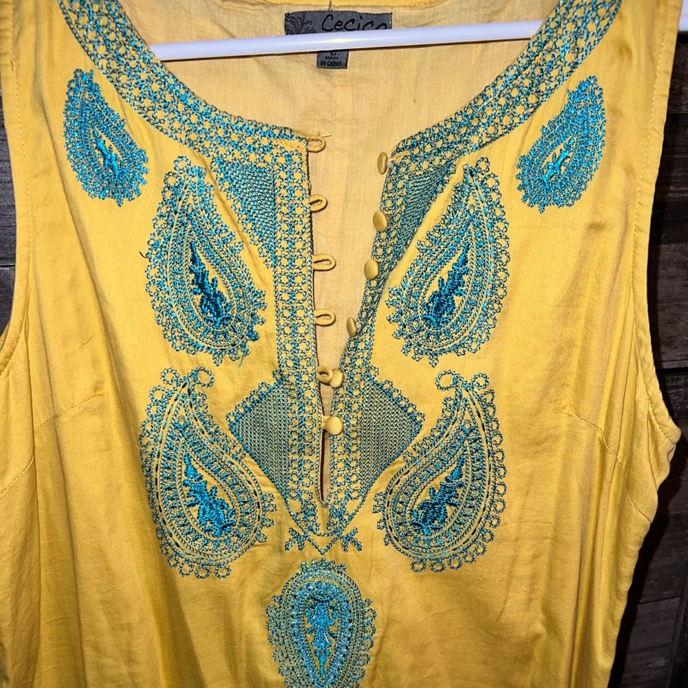 Large yellow with blue embroidery dress.